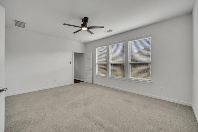 empty room with ceiling fan and light colored carpet