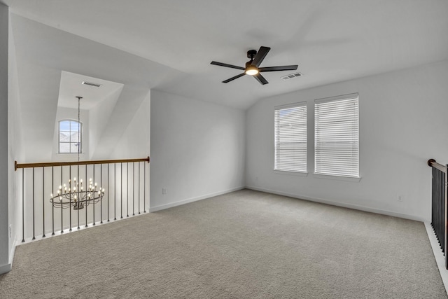 unfurnished room featuring carpet flooring, ceiling fan with notable chandelier, and lofted ceiling