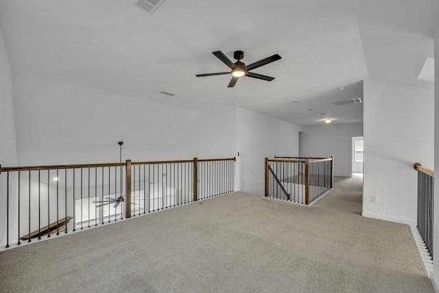 unfurnished room featuring ceiling fan and light carpet