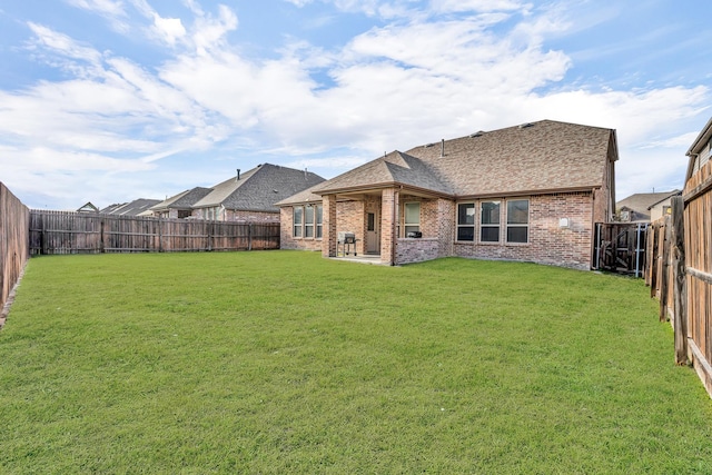 rear view of property with a lawn