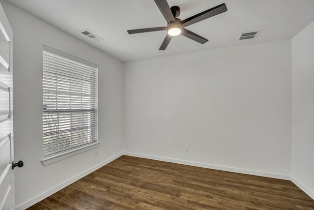 spare room with ceiling fan and dark hardwood / wood-style flooring