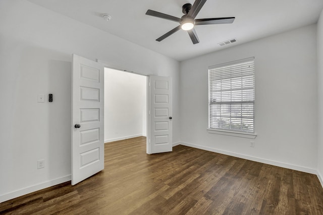 unfurnished bedroom featuring ceiling fan and dark wood-type flooring