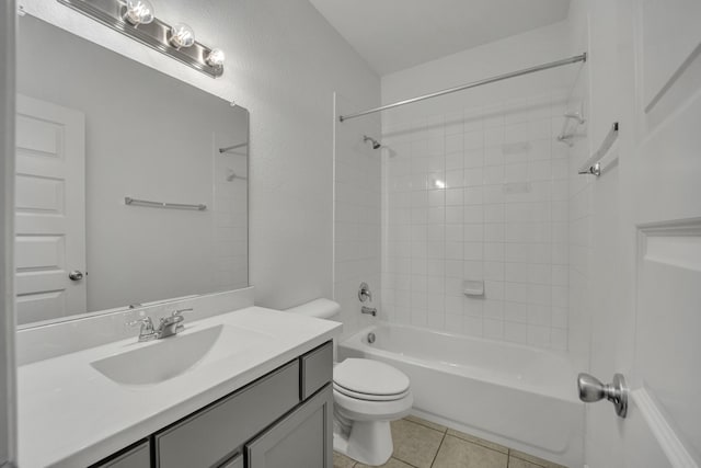 full bathroom featuring tile patterned flooring, vanity, tiled shower / bath combo, and toilet