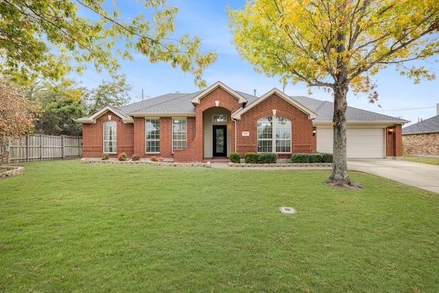 ranch-style house featuring a front yard and a garage