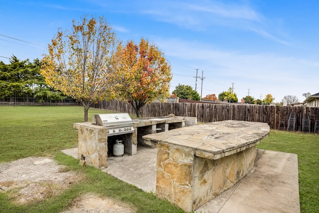 view of patio with exterior kitchen and area for grilling