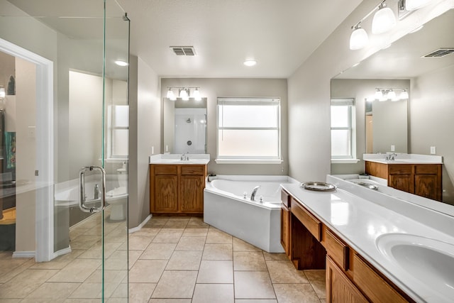 full bathroom featuring tile patterned flooring, vanity, shower with separate bathtub, and toilet