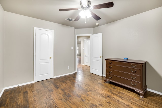 unfurnished bedroom with dark hardwood / wood-style floors and ceiling fan