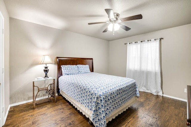 bedroom with dark wood-type flooring and ceiling fan