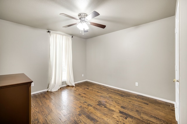 unfurnished room with dark wood-type flooring and ceiling fan