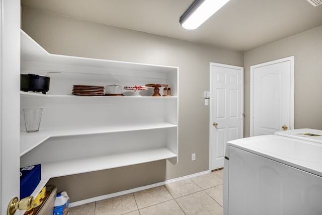 laundry room with separate washer and dryer and light tile patterned floors