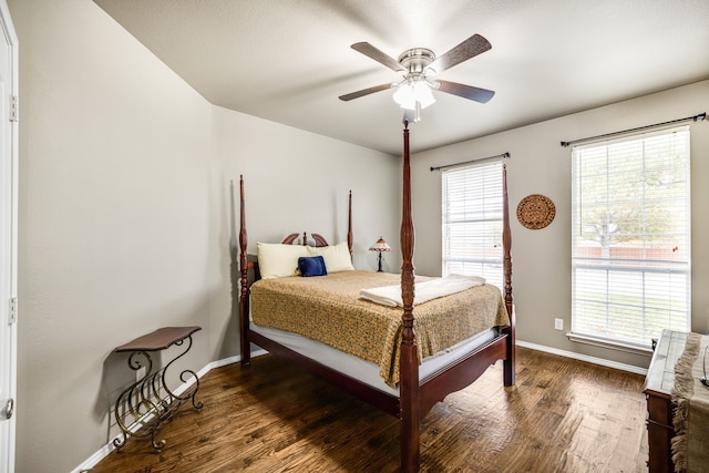 bedroom with dark hardwood / wood-style flooring, multiple windows, and ceiling fan