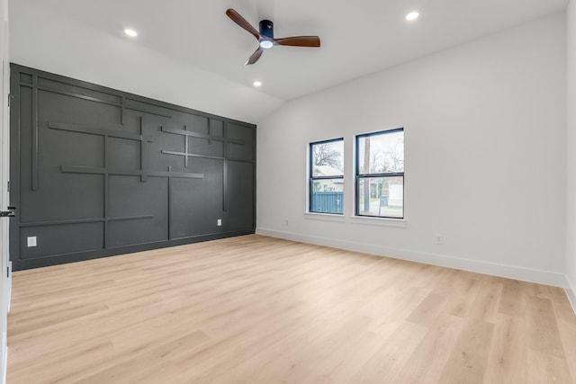 unfurnished bedroom featuring ceiling fan, vaulted ceiling, and light hardwood / wood-style flooring