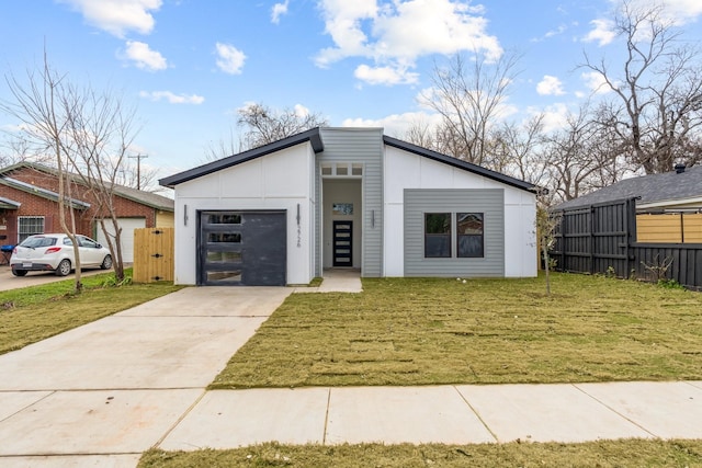 contemporary home featuring a front yard and a garage