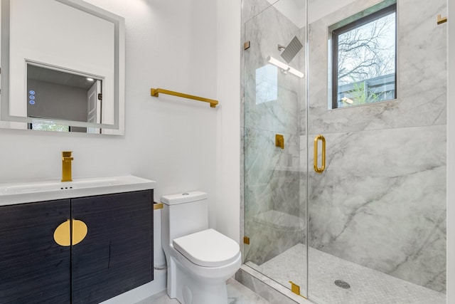 bathroom with toilet, an enclosed shower, and vanity