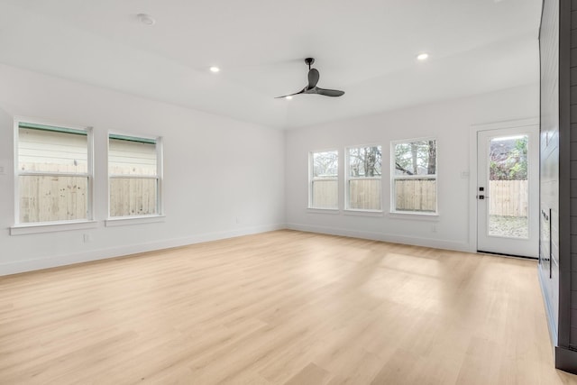 empty room with light hardwood / wood-style flooring and ceiling fan