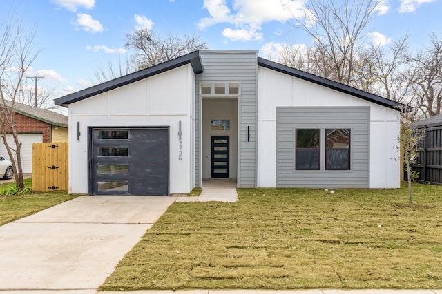 contemporary house featuring a front yard and a garage