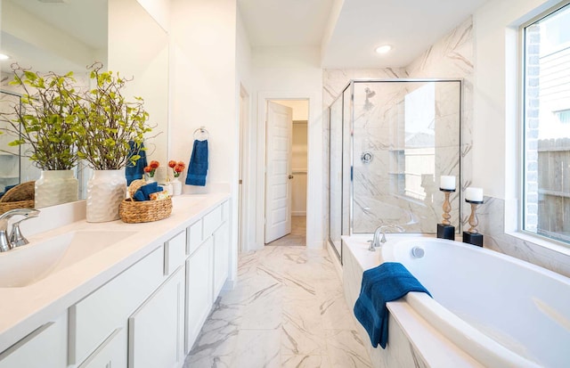 bathroom with vanity and independent shower and bath