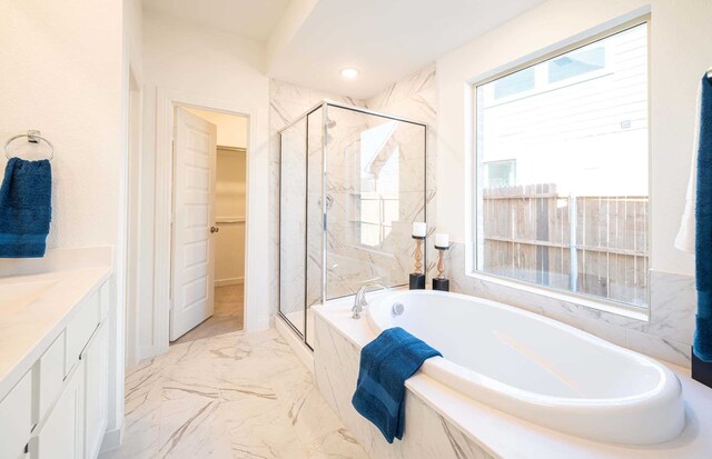 bathroom featuring vanity and separate shower and tub