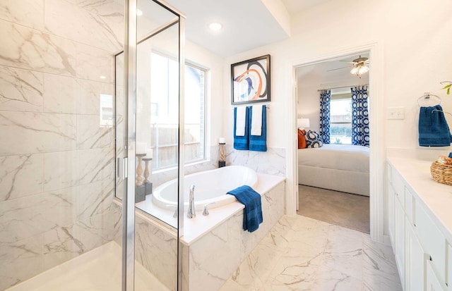 bathroom featuring ceiling fan, plus walk in shower, and vanity