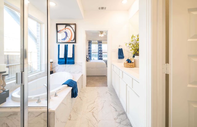 bathroom with a relaxing tiled tub and vanity