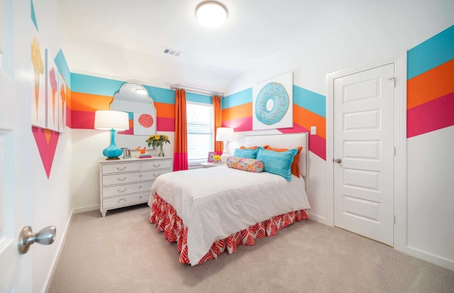 bedroom with light colored carpet and vaulted ceiling