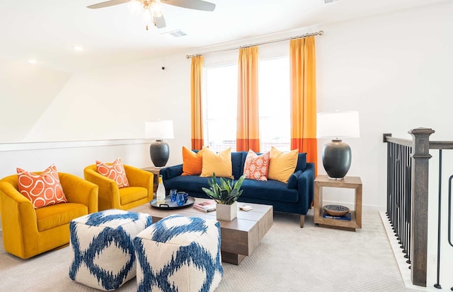 carpeted living room with ceiling fan