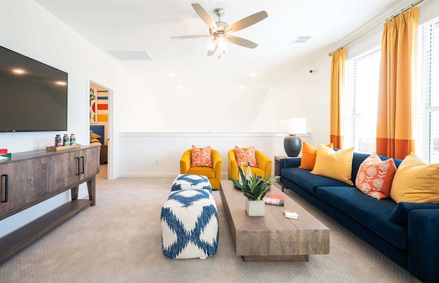 living room with light colored carpet and ceiling fan