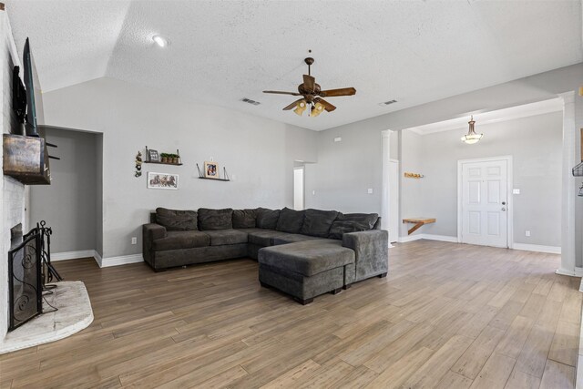 living room featuring hardwood / wood-style floors, a textured ceiling, and ceiling fan