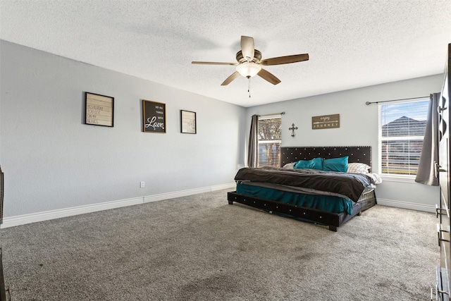 carpeted bedroom with ceiling fan and a textured ceiling