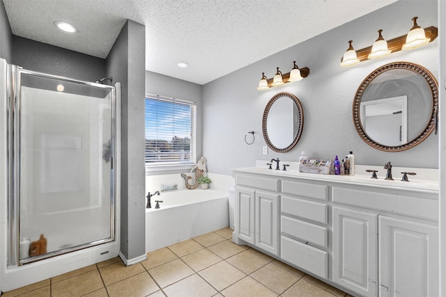 bathroom featuring tile patterned flooring, plus walk in shower, vanity, and a textured ceiling