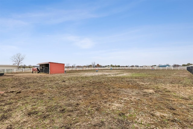 view of yard with a rural view and an outbuilding