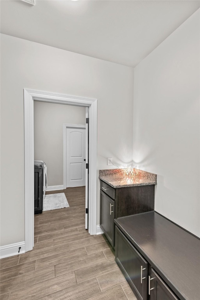 kitchen with washer / clothes dryer and dark brown cabinets