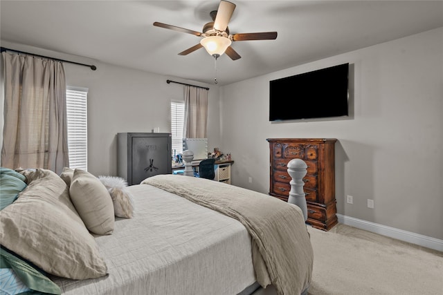 carpeted bedroom with multiple windows and ceiling fan