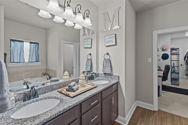 bathroom with a washtub and vanity