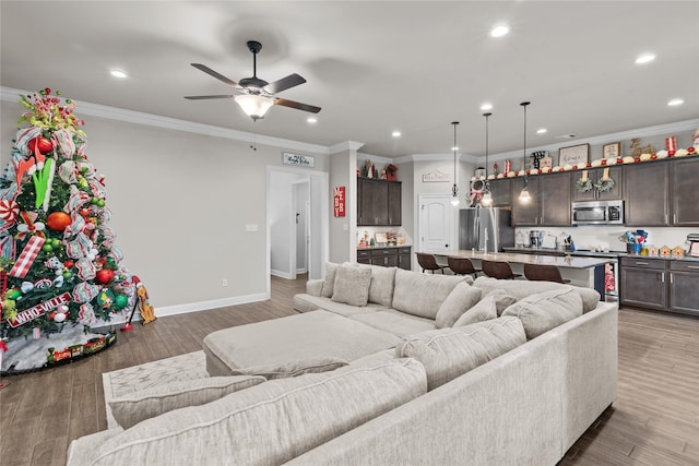 living room featuring crown molding, dark wood-type flooring, and ceiling fan