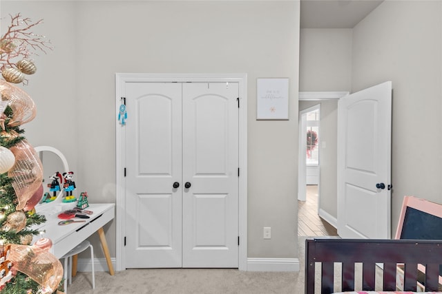 bedroom with light carpet and a closet