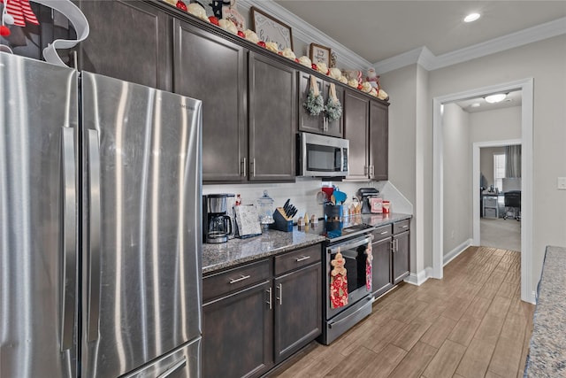 kitchen with dark stone countertops, dark brown cabinetry, crown molding, and appliances with stainless steel finishes