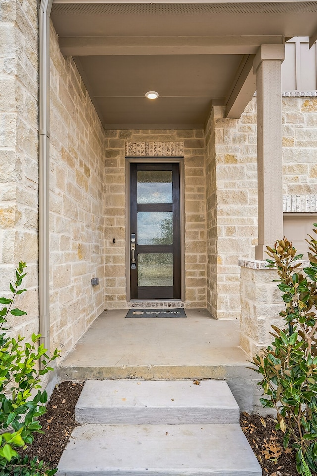 entrance to property with stone siding and brick siding