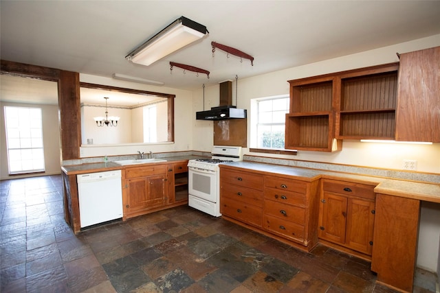 kitchen featuring sink, wall chimney exhaust hood, hanging light fixtures, a chandelier, and white appliances