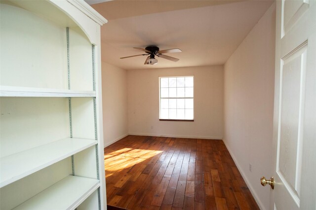 unfurnished room featuring ceiling fan and dark wood-type flooring