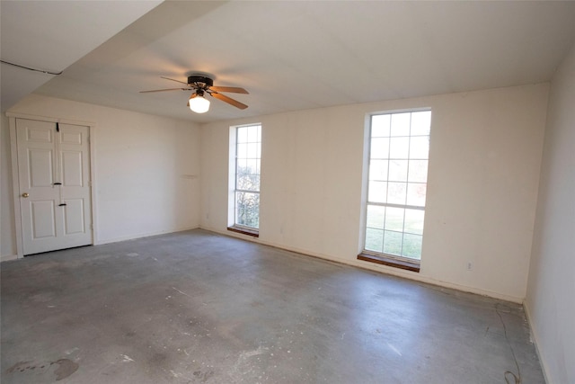 empty room featuring concrete floors and ceiling fan