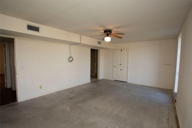 unfurnished room featuring ceiling fan and concrete flooring