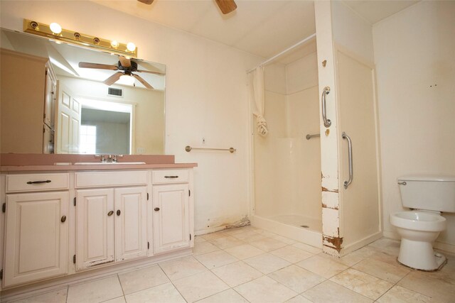 bathroom with ceiling fan, toilet, vanity, and walk in shower