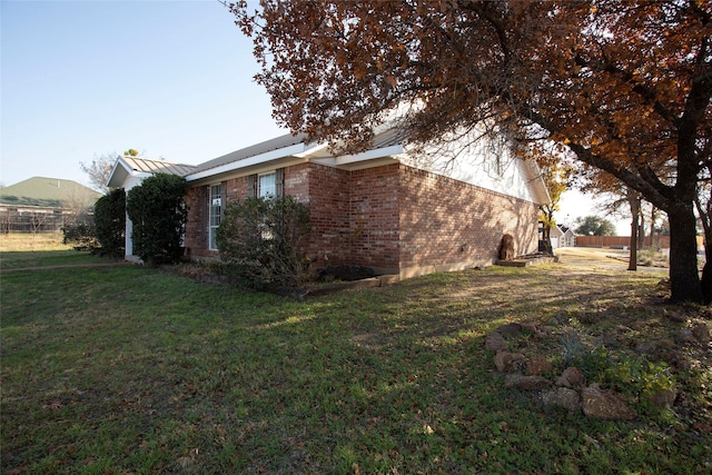 view of home's exterior with a lawn