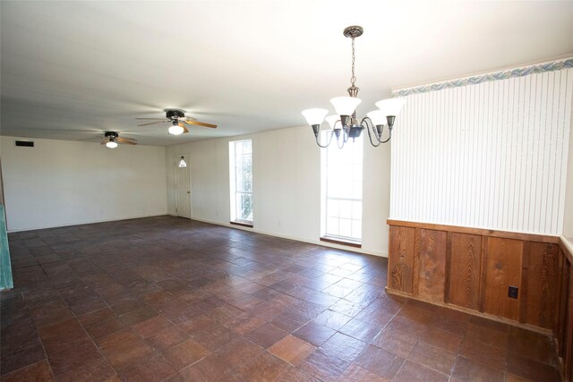 unfurnished room with ceiling fan with notable chandelier