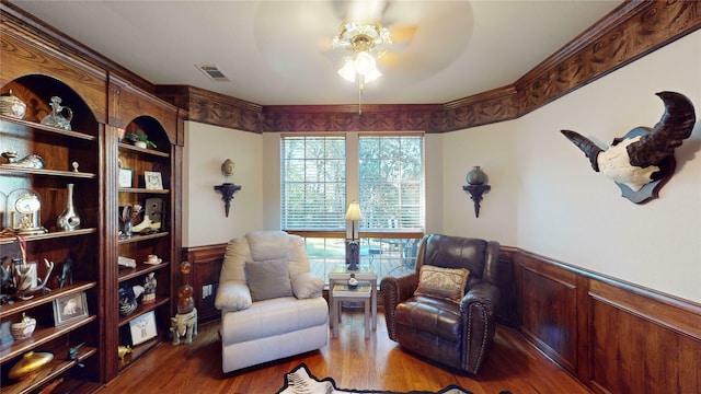 sitting room featuring ceiling fan and dark wood-type flooring