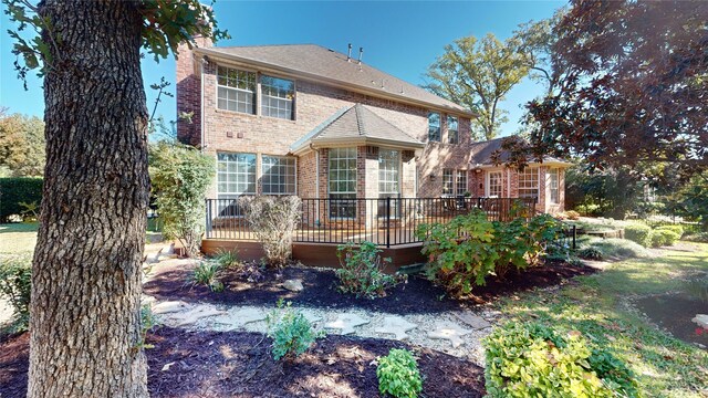 rear view of house featuring a deck