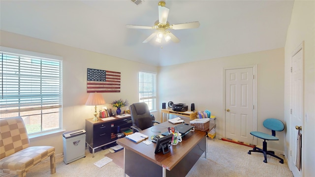 carpeted office with ceiling fan and a healthy amount of sunlight