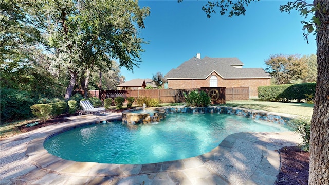 view of swimming pool with an in ground hot tub and pool water feature