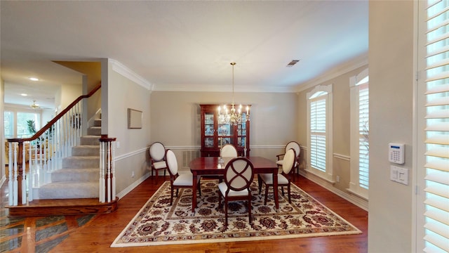 dining area featuring crown molding, plenty of natural light, and hardwood / wood-style flooring